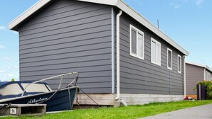 A single-story house with a grey siding exterior and a small attached garage. - Cozy home in Breukelen with WiFi (Breukelen)