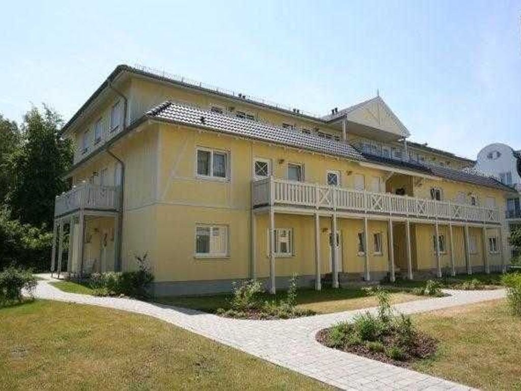 A two-story building with a balcony on the second floor.