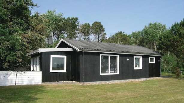 A small, single-story building with a dark exterior and white trim around the windows and roof. - Lovely home in Sæby with WiFi (Sæby)