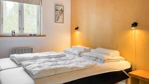 A bedroom with a bed, a window, a radiator, and a wall-mounted light fixture. - 1 bedroom lovely home in Kalundborg (Kalundborg)