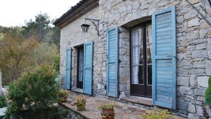 A stone building with blue shutters, a stone staircase, and potted plants. - Awesome home in La Roquette sur Siagne (La Roquette sur Siagne)