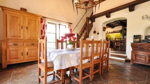 A rustic dining area with wooden furniture, a chandelier, and a view into the kitchen. - Awesome home in La Roquette sur Siagne (La Roquette sur Siagne)