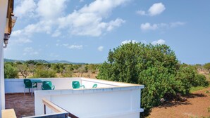 A rooftop terrace with a view of a mountainous landscape, surrounded by greenery and a clear sky. - Beach front home in Porto Cristo (Porto Cristo)
