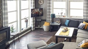 A living room with a TV, sofa, coffee table, and a fireplace. - Lovely home in Rauland with sauna (Rauland)