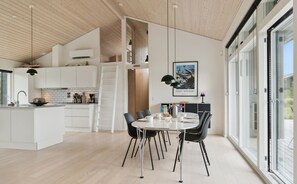 Enjoy meals in the adjacent dining area with a round table and comfortable seating.