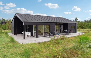 Relax on the spacious deck with a dining area and seating, perfect for unwinding or entertaining.
