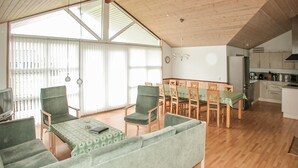 A spacious living area with a sofa, chairs, a dining table, and a kitchen area. - Lovely home in Tarm with sauna (Tarm)