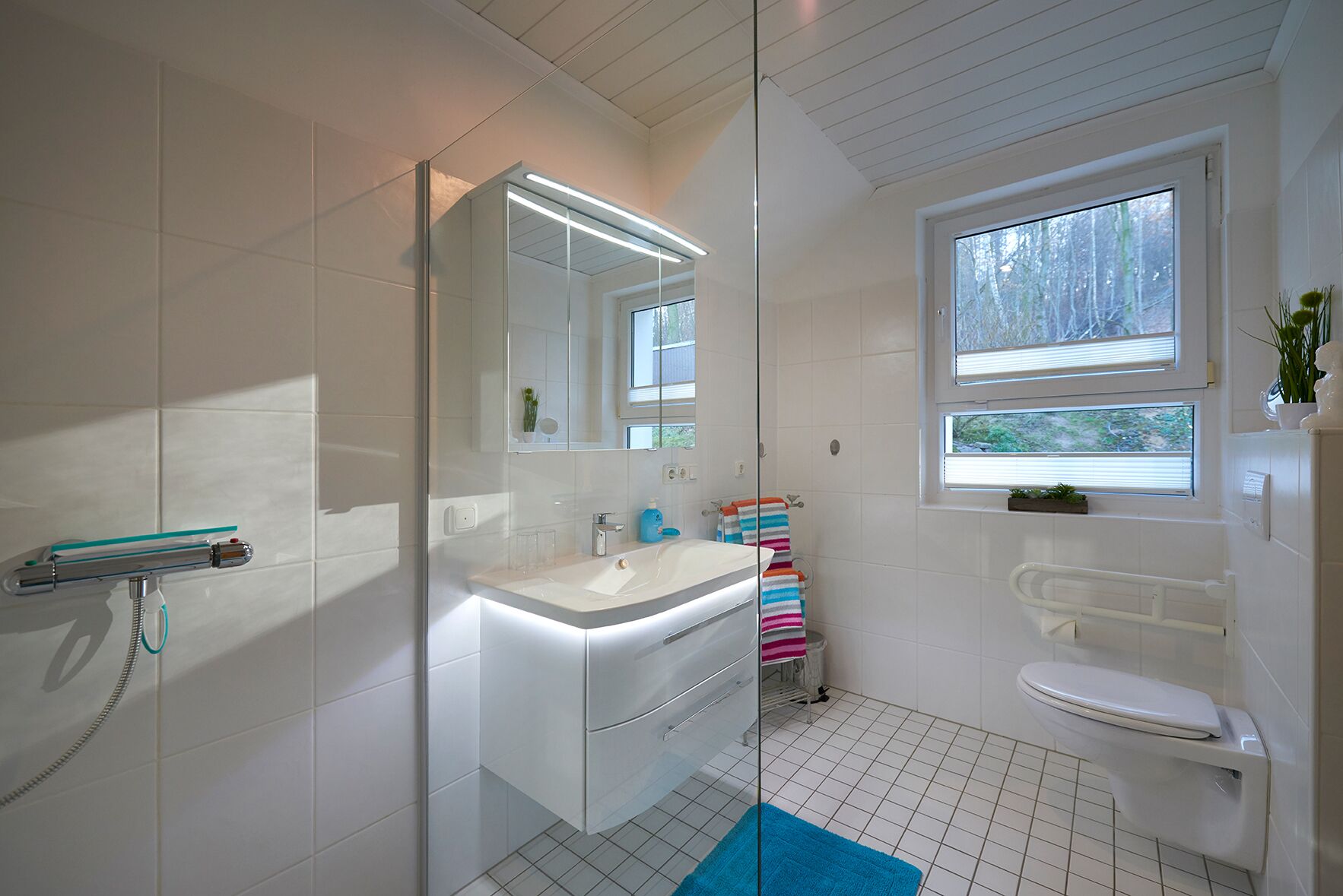 Shower, hair dryer, slippers, towels