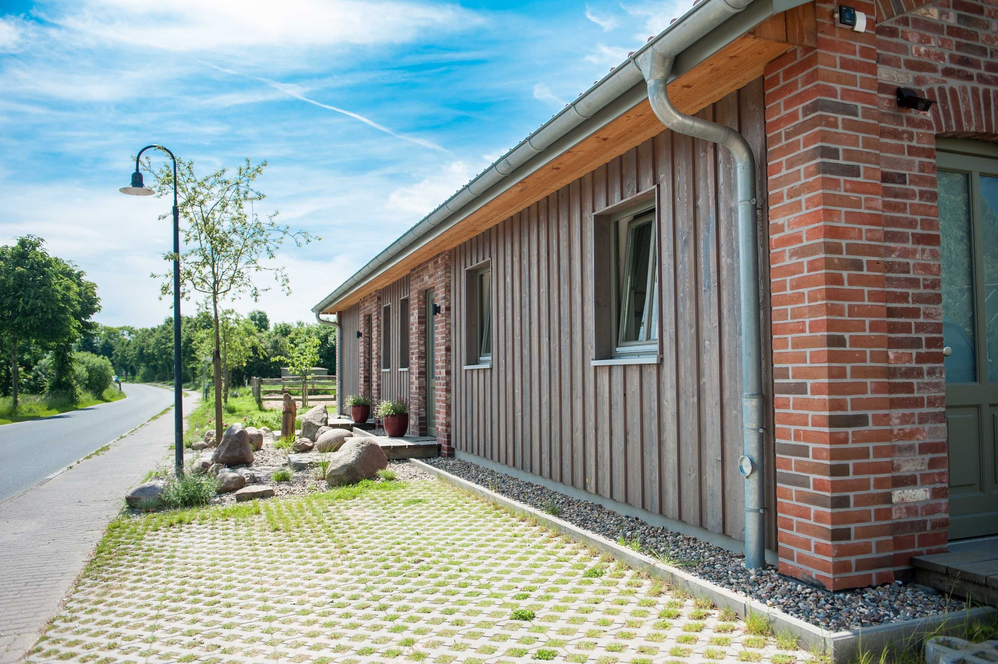 A building with a brick facade and a wooden overhang.