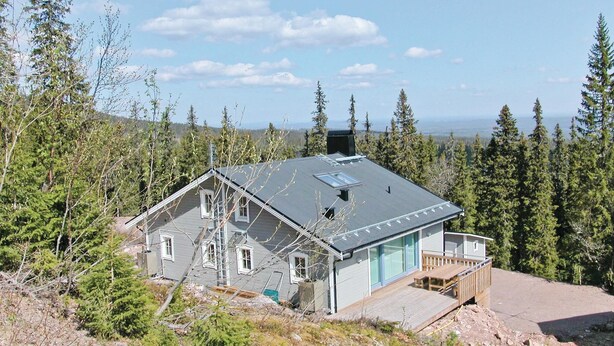 A modern house with a sloped roof, large windows, and a deck. - 5 bedroom gorgeous home in Sälen (Sälen)