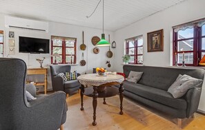 Relax in this inviting living room with a large flat-screen TV, comfortable sofa, and stylish coffee table.