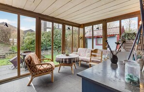 Enjoy a garden view from the large windows, with comfortable seating and a bar area.