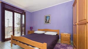 A bedroom with a wooden bed, a nightstand, a dresser, and a window with curtains. - 2 bedroom gorgeous apartment in Rogoznica (Rogoznica)