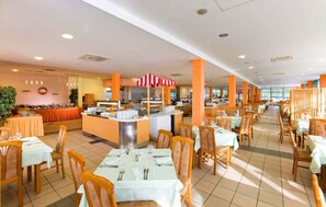 Enjoy a casual dining experience with a central buffet station and comfortable seating arrangements.