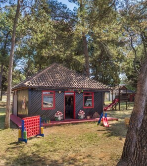 Escape to a serene cabin surrounded by nature, with a front door and windows, and a small porch area.