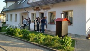 A building with a tiled roof, a sign reading "Brüder Fischladen," and a small red chimney. - Holiday apartment on Blankensee (Trebbin)