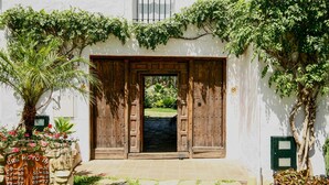 A wooden door with a sign indicating room numbers 16-73.