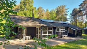 A cabin with a tiled roof, large windows, and a deck area. - 3 bedroom stunning home in Sæby (Sæby)