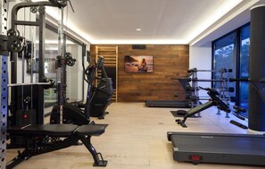 A gym with exercise equipment, a treadmill, and a large window with a view. - Amazing apartment in Binz with WiFi (Prora/Rügen)