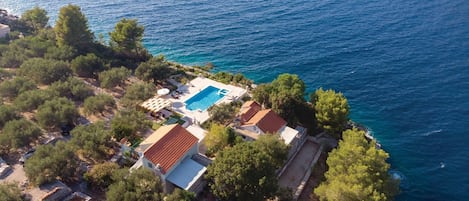 Overlooking the sea, this villa features a pool and lush surroundings.
