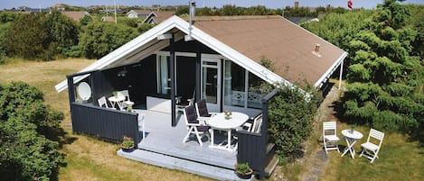 A two-story house with a balcony and a patio area.