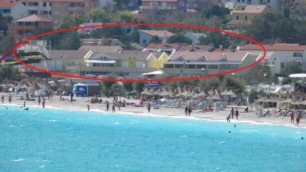A coastal hotel with multiple floors, beach access, and a visible swimming pool. - Holiday apartment near the beach with air conditioning (Baška)