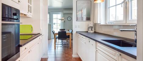 Fridge, stovetop, dishwasher, coffee/tea maker