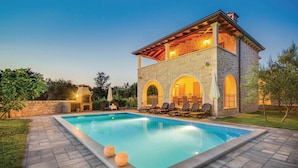 A two-story stone building with a swimming pool, outdoor seating, and a barbecue area. - Stunning home in Turcic (Turcic)