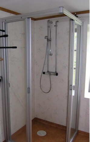 A glass-enclosed shower area with a showerhead and hose, a door, and a small window. - Pet friendly home in Skillingaryd (Skillingaryd)