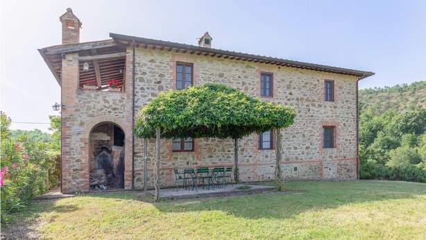 A stone building with a small balcony, a chimney, and a bench outside. - Amazing apartment in S.Vito In Monte TR (S.Vito In Monte TR)