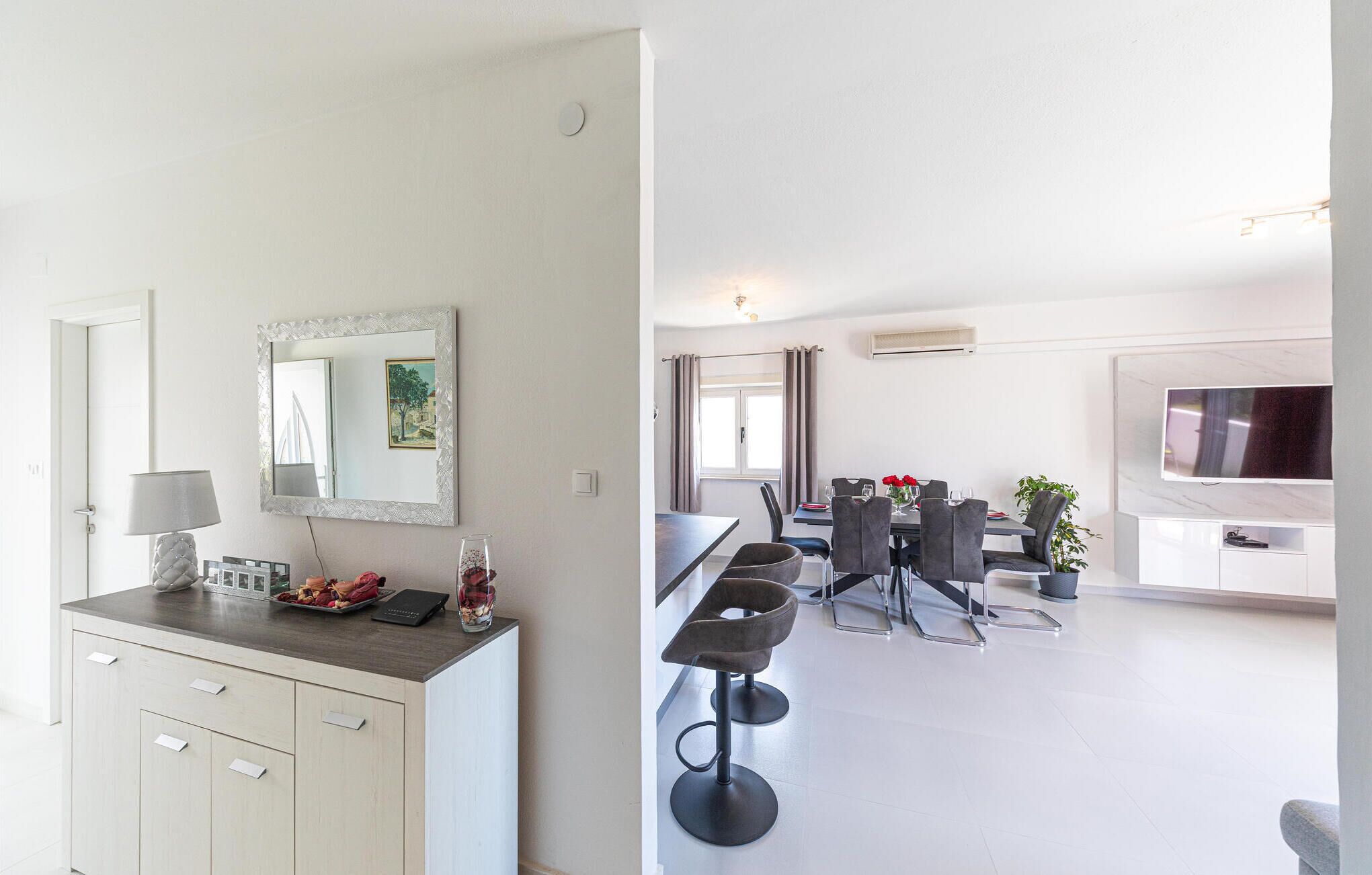 A modern kitchen with a dining area.