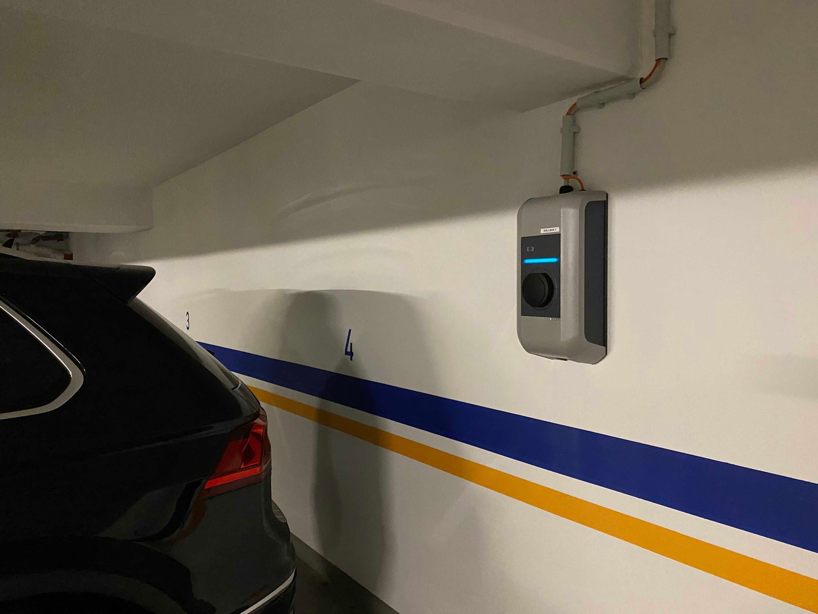 A parking garage with a car parked in a spot marked with the number 4.