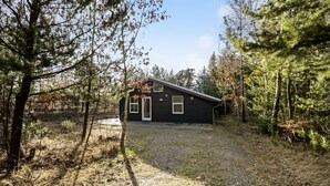 A cabin with a sloped roof, a front door, and a small porch area. - Beautiful home in ålbæk with sauna (Ålbæk)