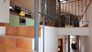 A staircase with a metal railing leading to a second floor. - Holiday apartment with barbecue, internet and air conditioning (Šilo)
