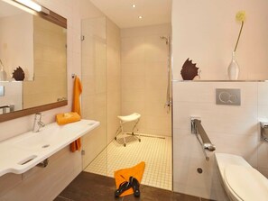 Une salle de bain moderne équipée d’une douche, de toilettes et d’un lavabo.