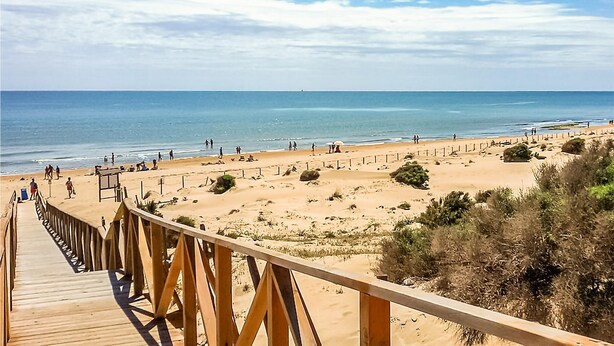 A wooden boardwalk leading to a sandy beach with clear skies. - 2 bedroom stunning apartment in Rojales (Rojales)
