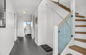 Enter a serene space with a bedroom area featuring a bed and a window offering a view of the outdoors.