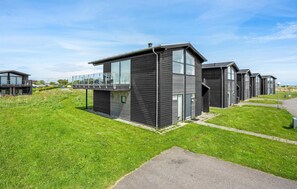 Residential complex with modern architecture and large windows.