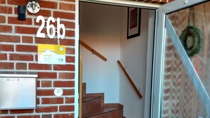 Parede de tijolos com uma porta identificada com 