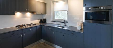 Fridge, stovetop, dishwasher, coffee/tea maker