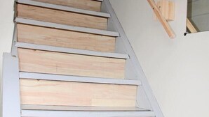 A wooden staircase with white railings and a handrail.