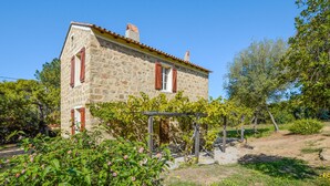 A stone house with red shutters, surrounded by greenery and trees. - Awesome home in Coti-Chiavari (Coti-Chiavari)