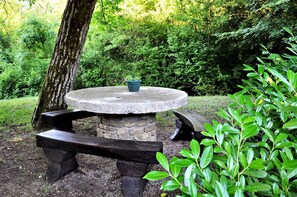 Sit and unwind in a serene outdoor space surrounded by lush greenery.