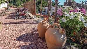 Terracotta pots, a wooden fence, and flowering plants in a garden setting. - Nice home in Tossa de Mar with WiFi (Tossa de Mar)