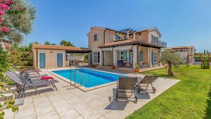 A two-story house with a swimming pool, outdoor seating, and a garden. - Luxurious home in Fazana with sauna (Fazana)