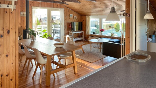 A wooden interior with a dining area, a kitchen, and a living space. - Amazing home in Egernsund with WiFi (Egernsund)