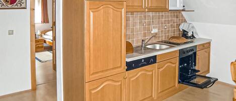 Fridge, stovetop, dishwasher, coffee/tea maker