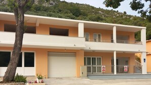 A two-story building with balconies, a garage, and a no parking sign. - 3 bedroom gorgeous home in Duba (Duba)