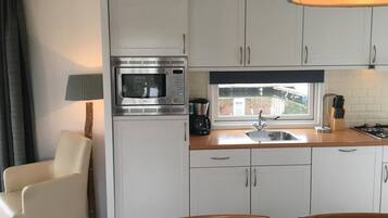 Fridge, stovetop, dishwasher, coffee/tea maker