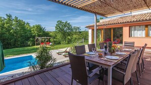 A covered outdoor dining area with a pool, wicker furniture, and a view of the surrounding greenery. - Stunning home in Sv.Petar u Sumi (Sv.Petar u Sumi)